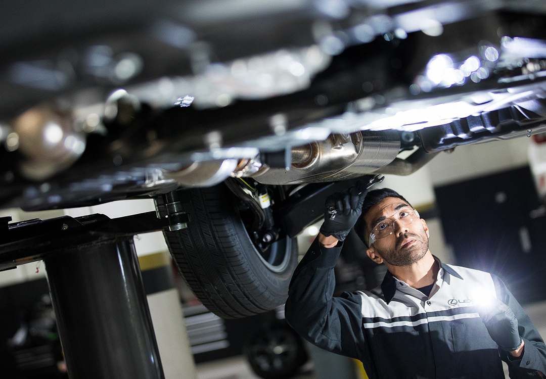 A mechanic underneath a car