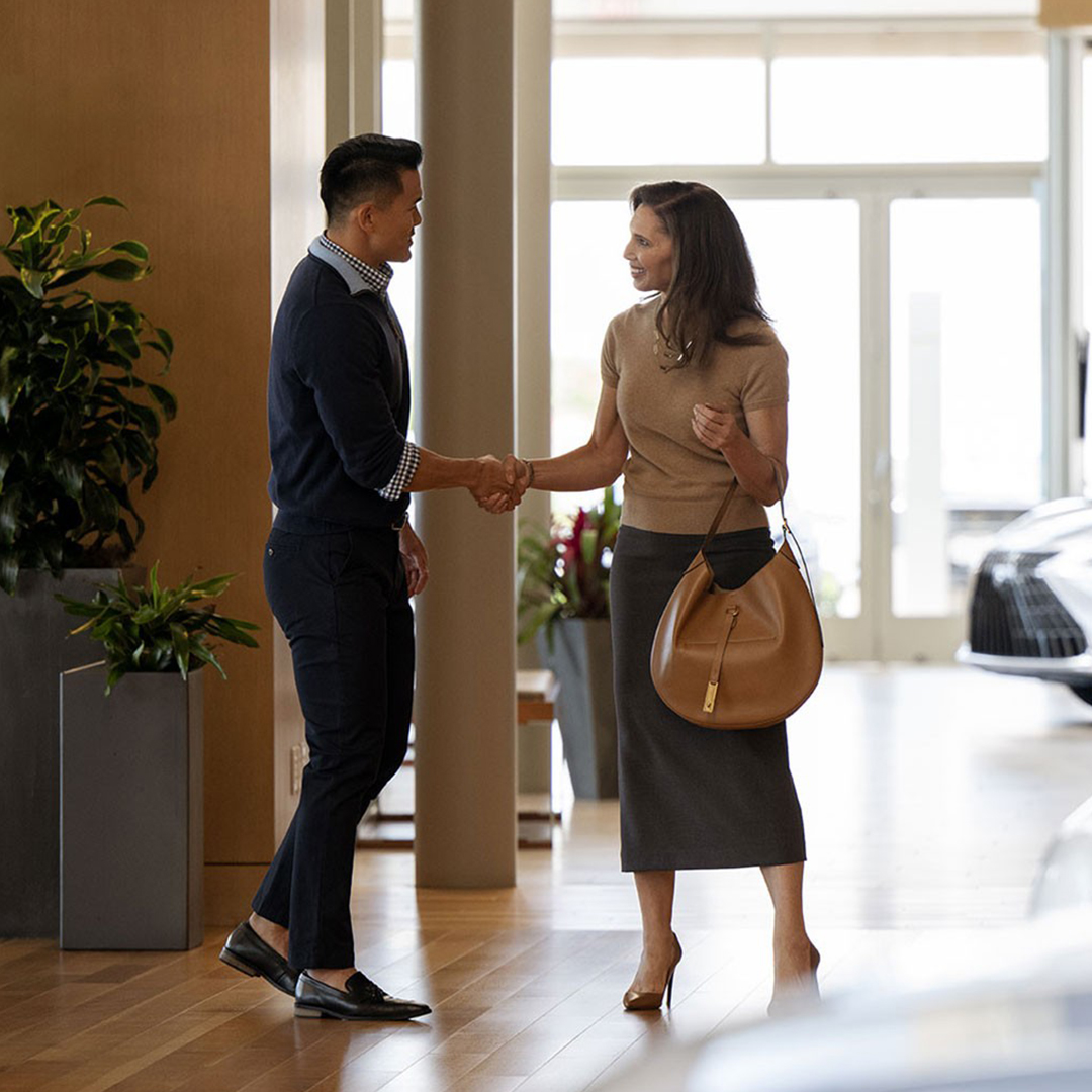 A woman and a man stand in a dealership