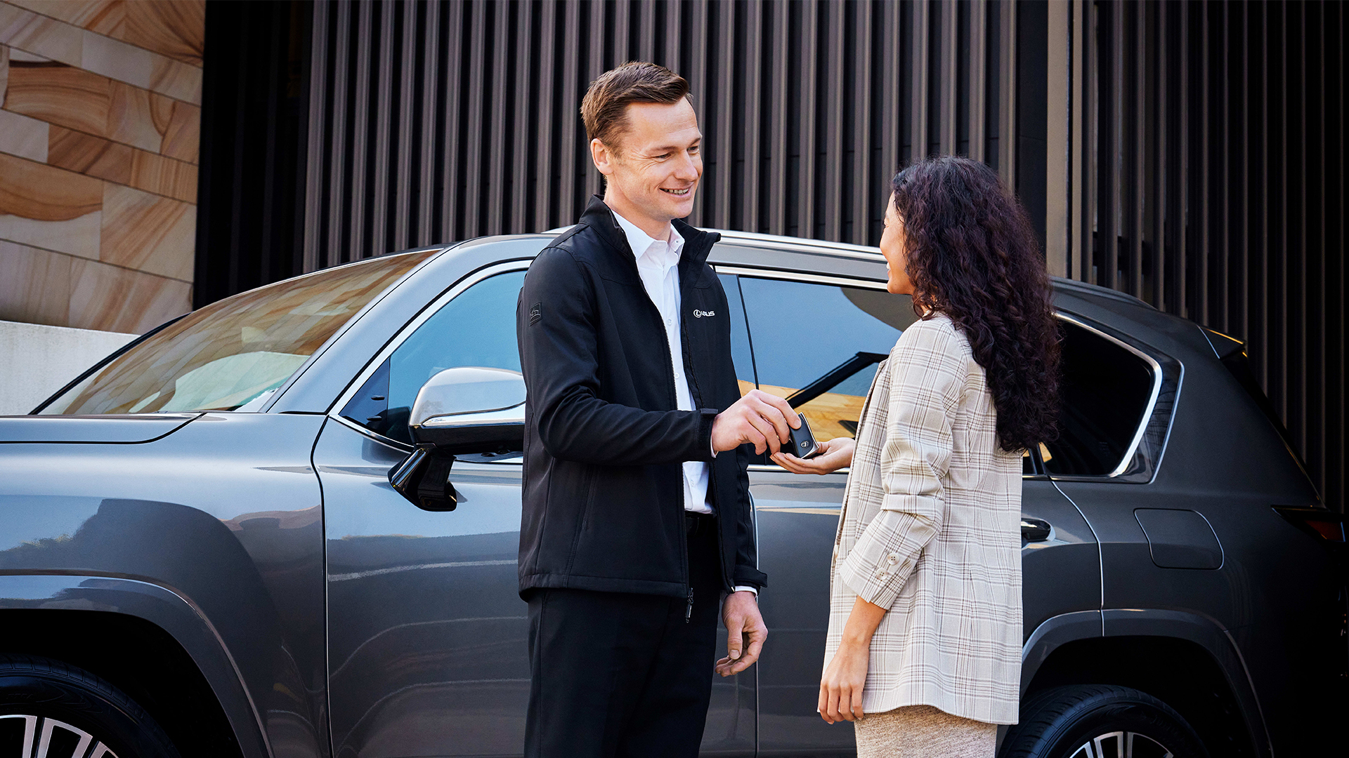 A man handing a woman keys 