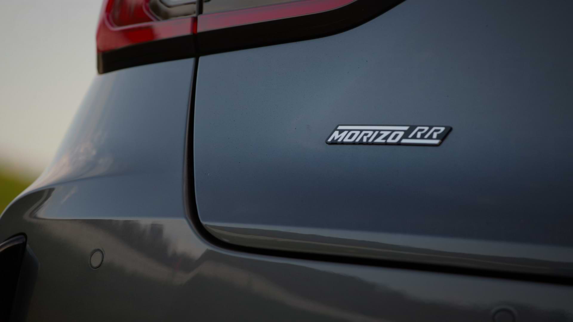 Logo with text 'Morizo RR' at the back of a car.